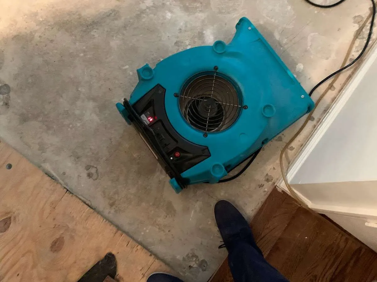 Air mover drying subfloor during Commercial Water Damage Restoration in University City